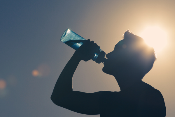 man drinking water on a hot day