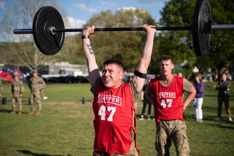 Competitor lifting weights above head