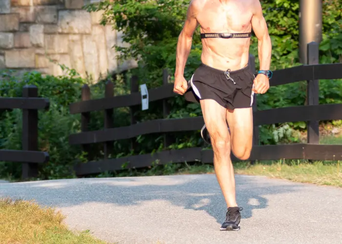 runner with chest strap monitor outdoors