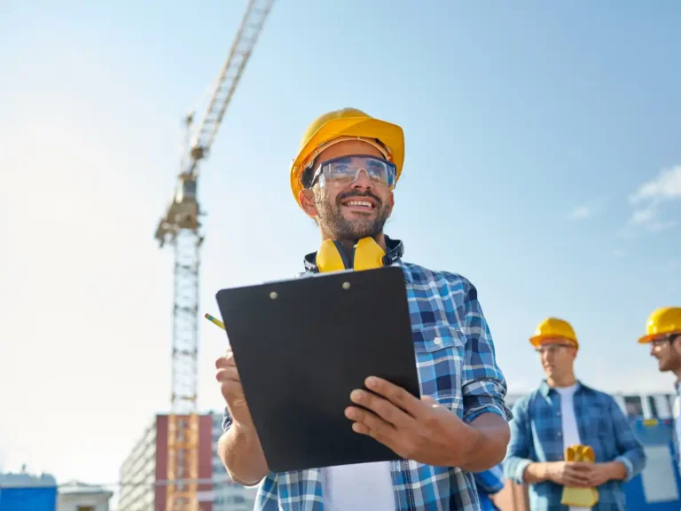 construction worker with clipboard outside a worksite